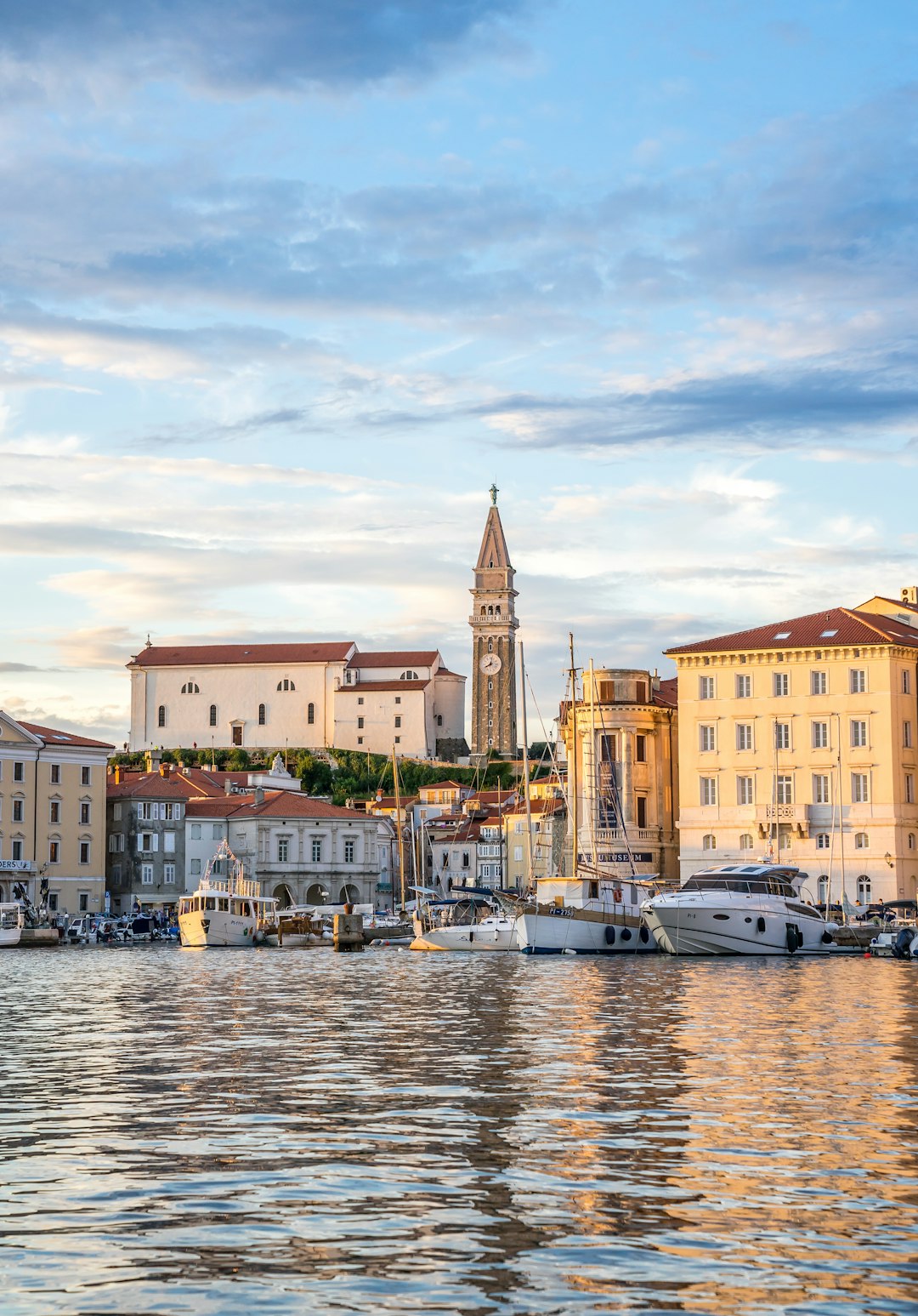 piran - a harbor filled with lots of boats under a cloudy sky